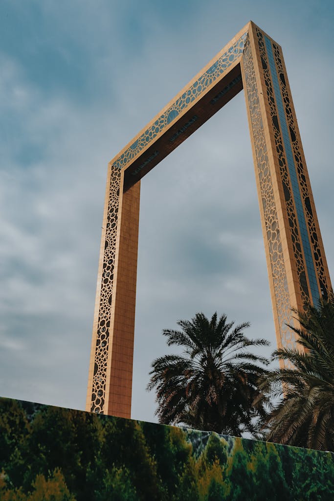 From below exterior of creative contemporary construction build in shape of rectangular photo frame in Dubai UAE on clear hot day